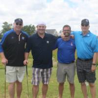 4 more men playing golf